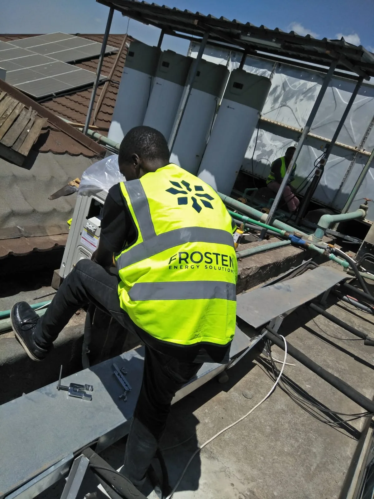 Frosten technician working on a rooftop plant installation